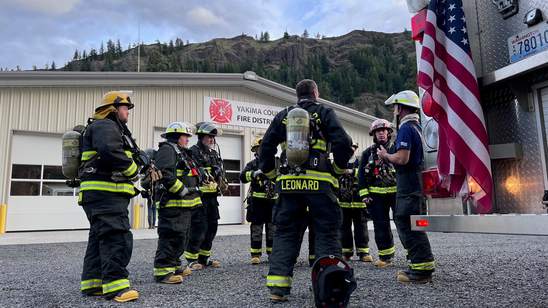 Nile-Cliffdell firefighters gather in a crew huddle outside the station