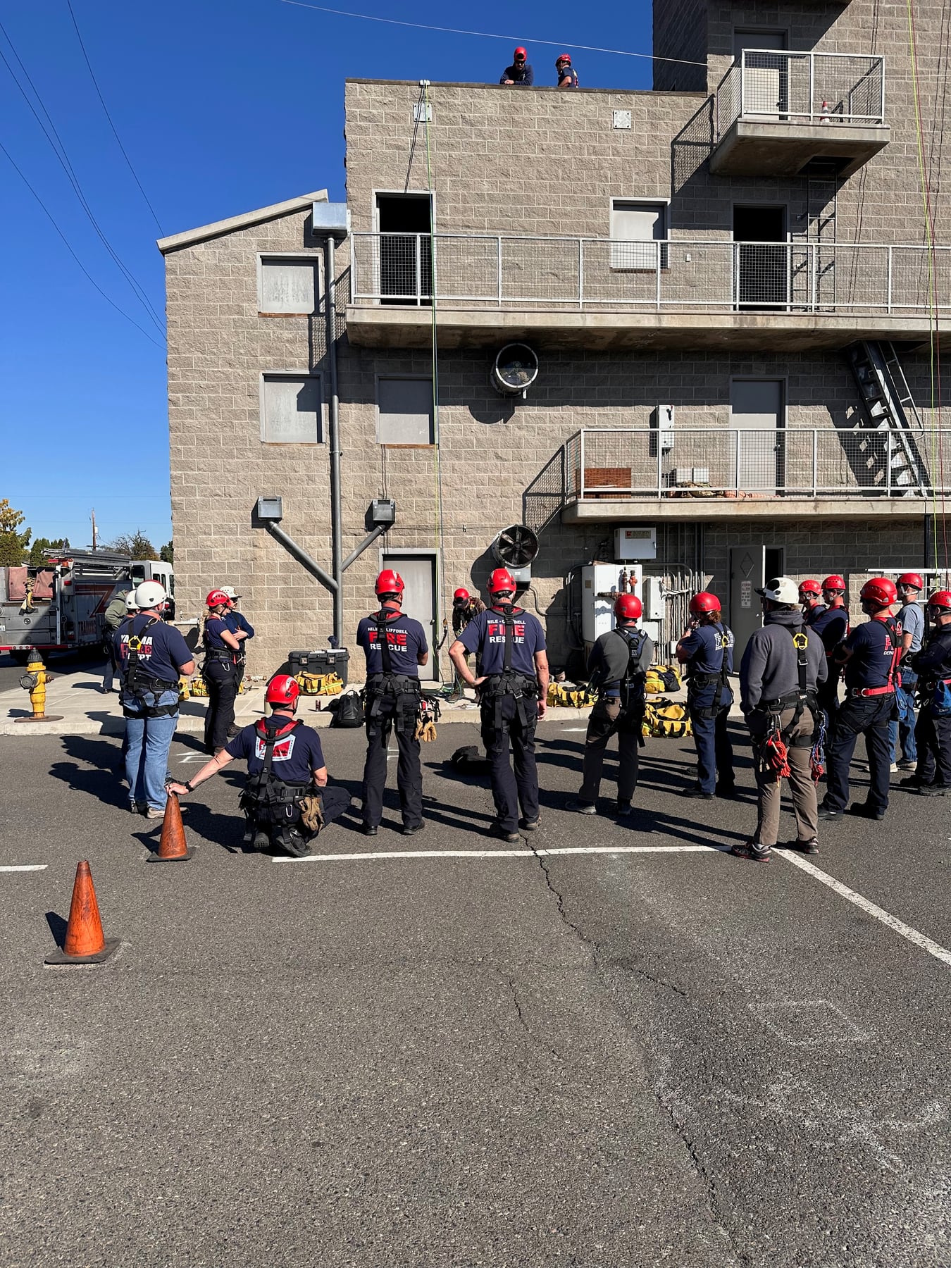 Department members gather at a training tower for a group drill