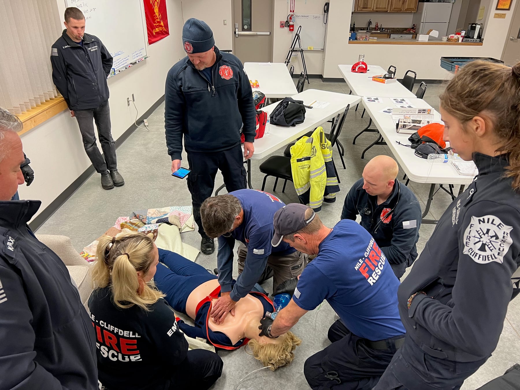Firefighters and EMTs practice coordinated patient care during a department drill