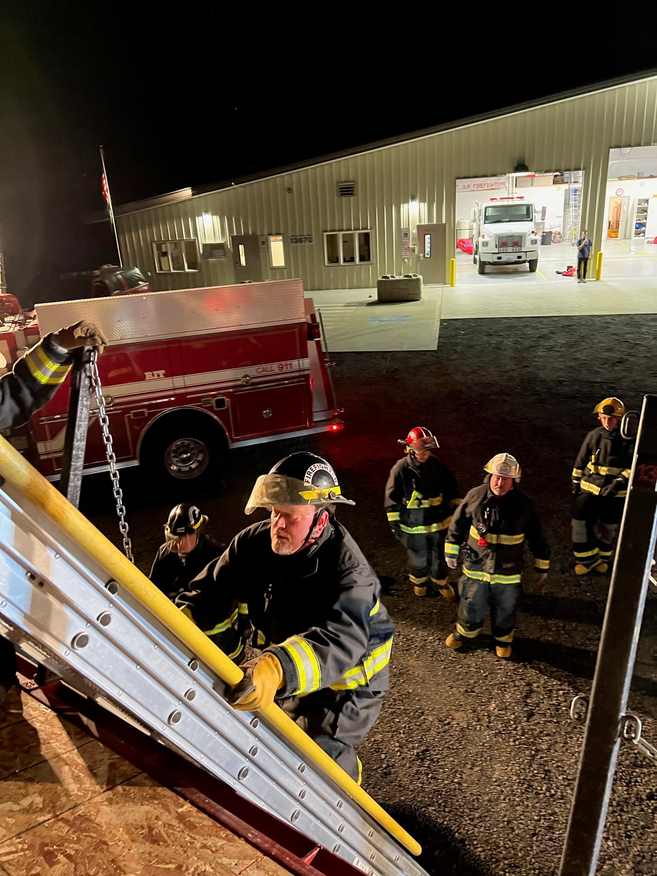 Firefighters work together during nighttime vehicle-rescue training