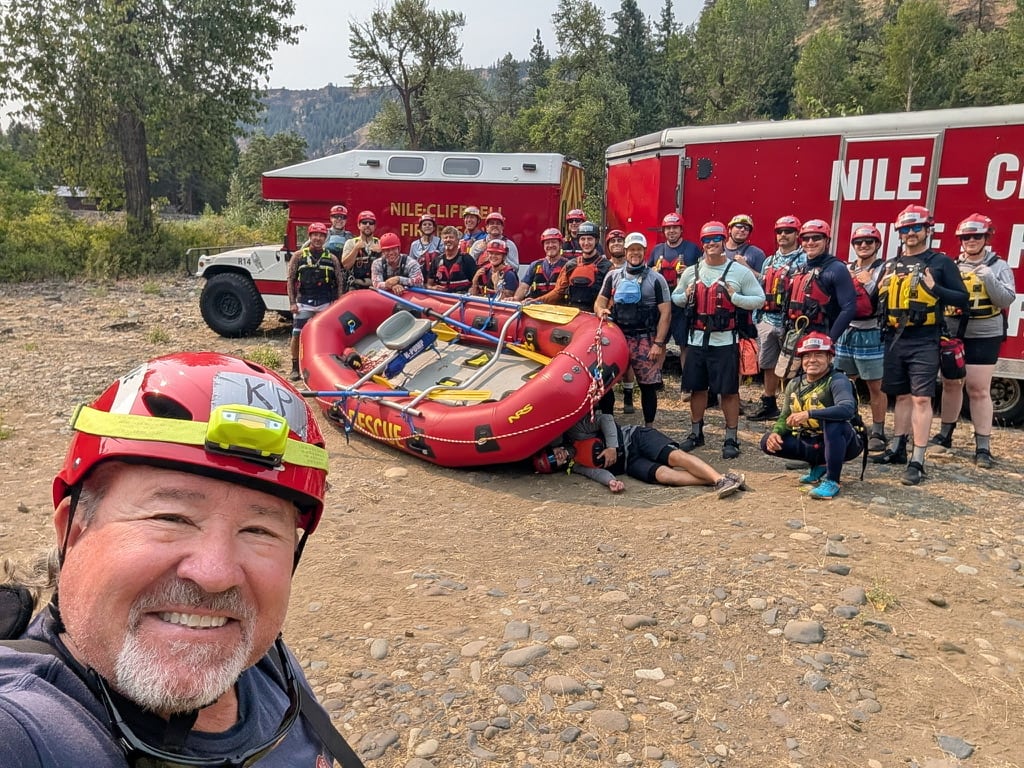 Nile-Cliffdell firefighters and rescue partners gather beside a rescue raft after swiftwater training