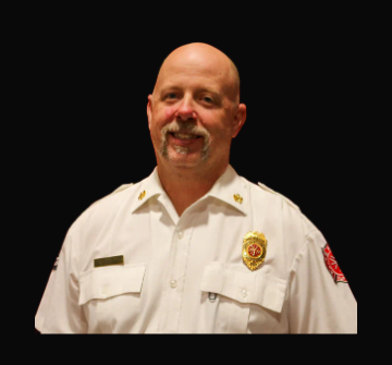 Fire Chief Ryan Clark in a white command uniform