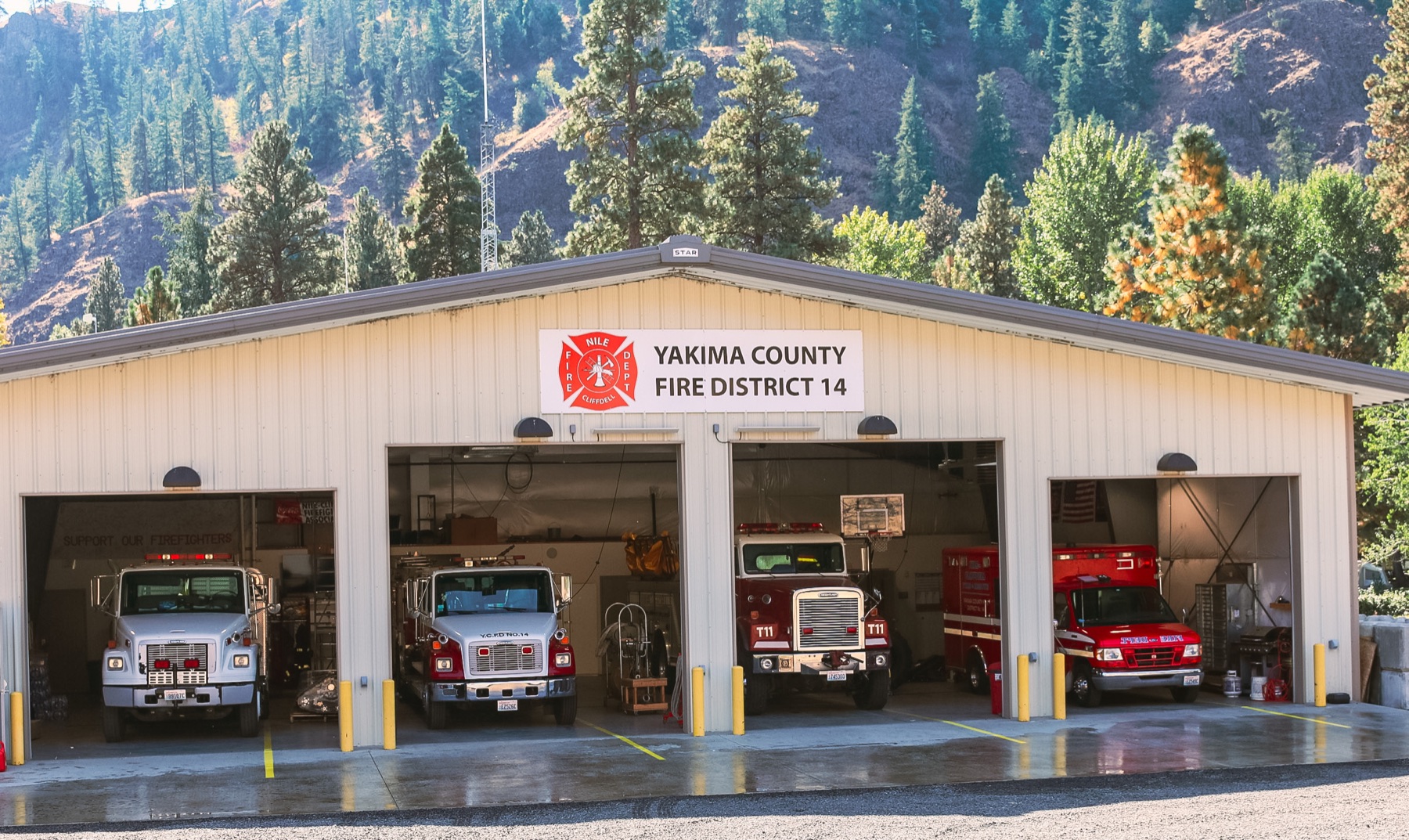 Station 11 apparatus bays open with district fire and rescue vehicles inside